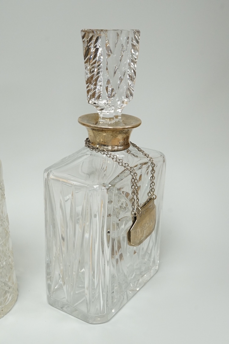 A late Victorian silver mounted cut glass mug, Saunders & Shepherd, Chester, 1899, height 13.4cm, together with a modern silver mounted cut glass decanter and a modern pair of silver 'Whisky' and 'Brandy' wine labels, J.